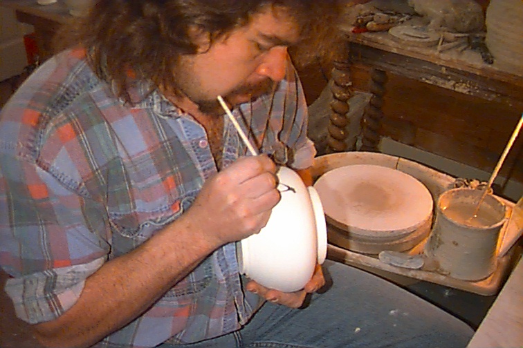 Mike Peters painting a pottery piece he made